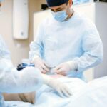 pexels-photo-4769130-4769130 Doctors in protective gear performing surgery in a sterile operating room.